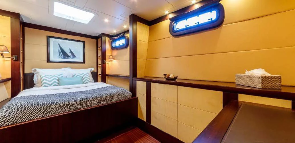 a room with a bed and a tv on the wall aboard ALLURES Yacht for Charter