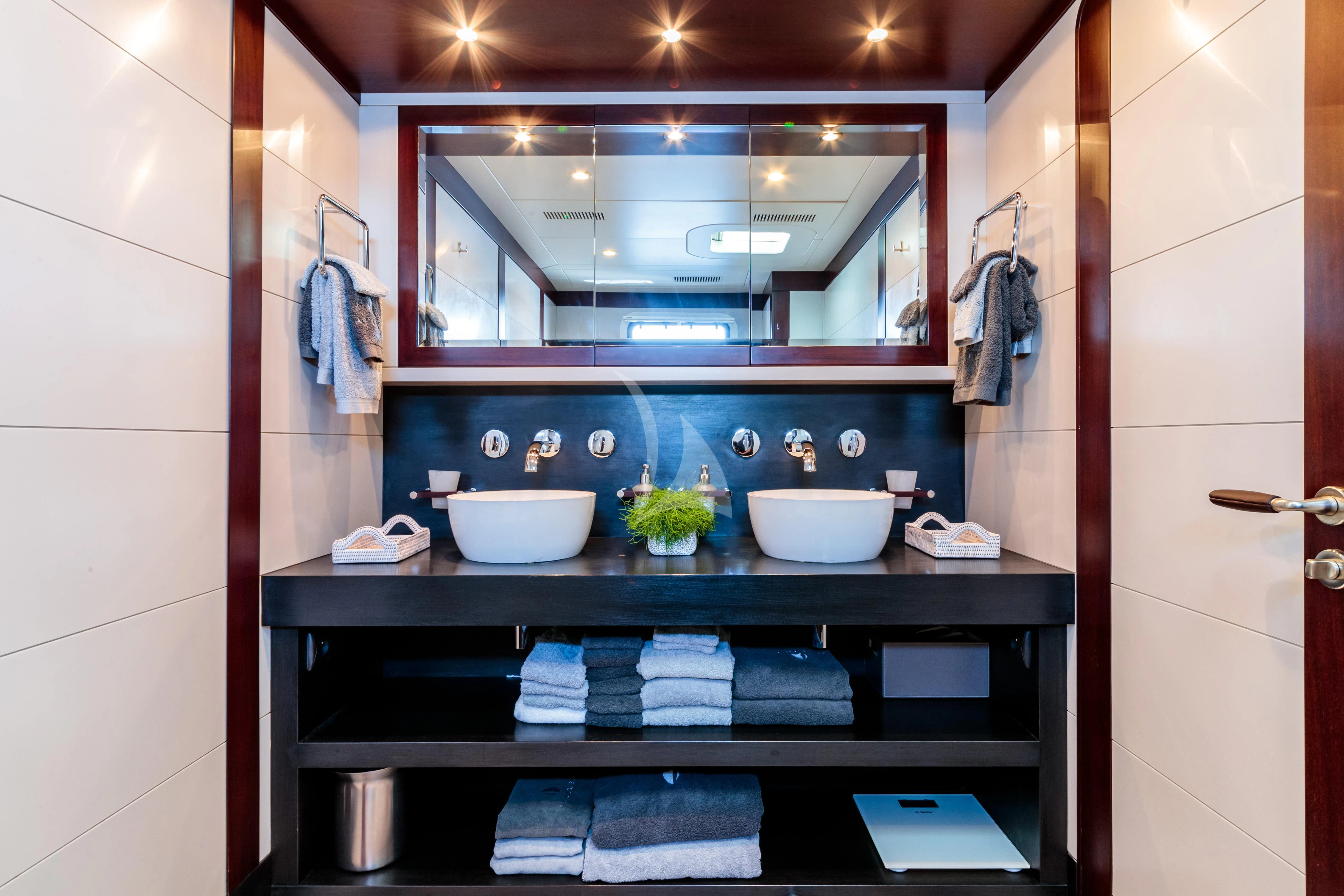 a bathroom with a large mirror aboard ALLURES Yacht for Charter