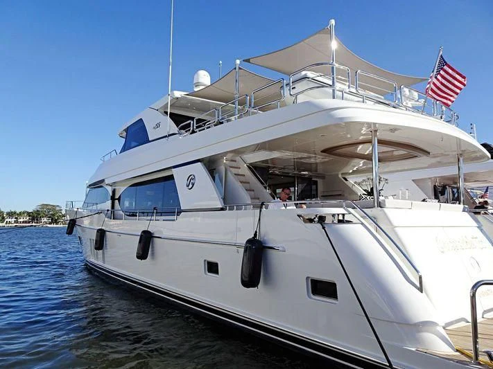 a large white boat with a flag on it aboard THE KING AND I Yacht for Sale