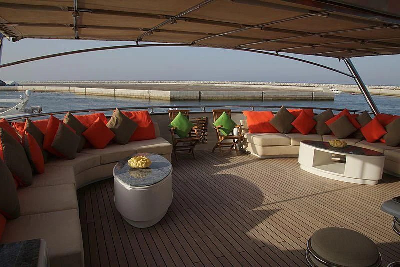 a deck with couches and chairs aboard AMARA Yacht for Sale