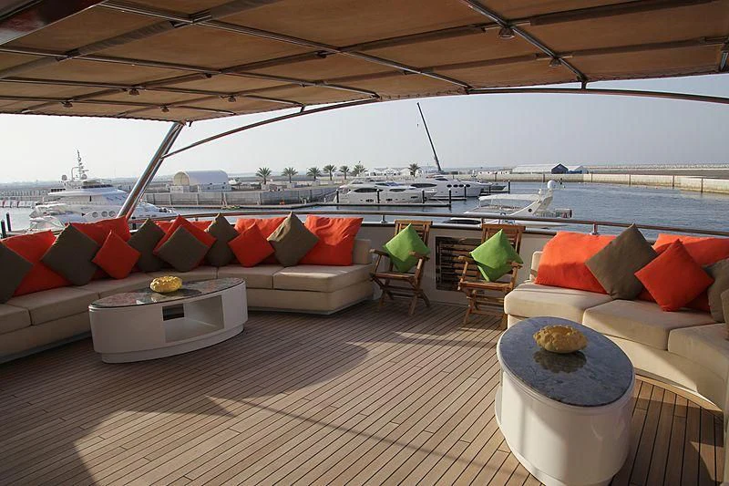 a patio with a couch and a table and chairs aboard AMARA Yacht for Sale