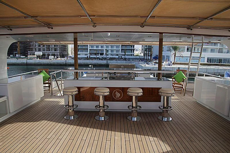 a room with tables and chairs aboard AMARA Yacht for Sale