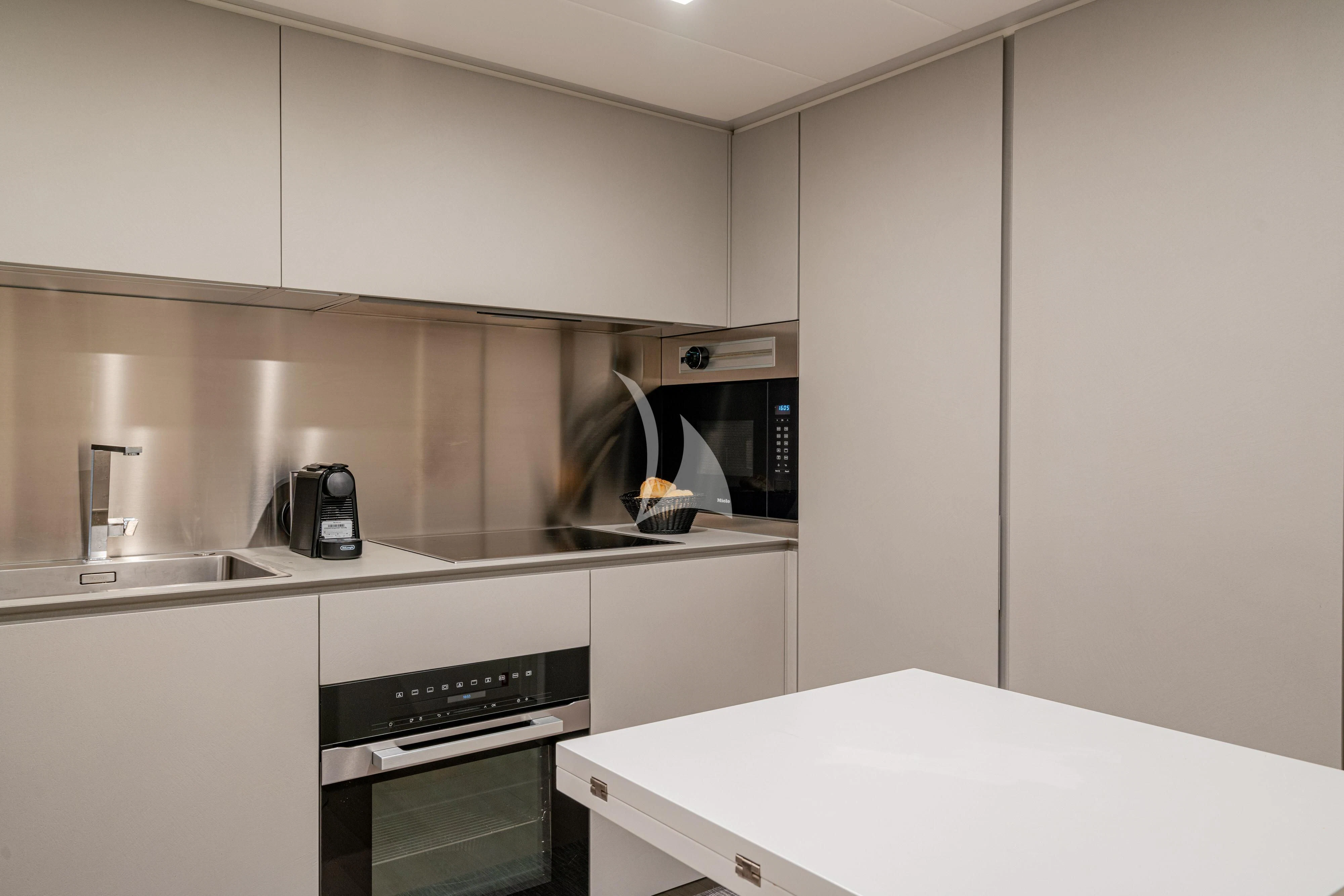 a kitchen with white cabinets aboard SOPHIA Yacht for Sale