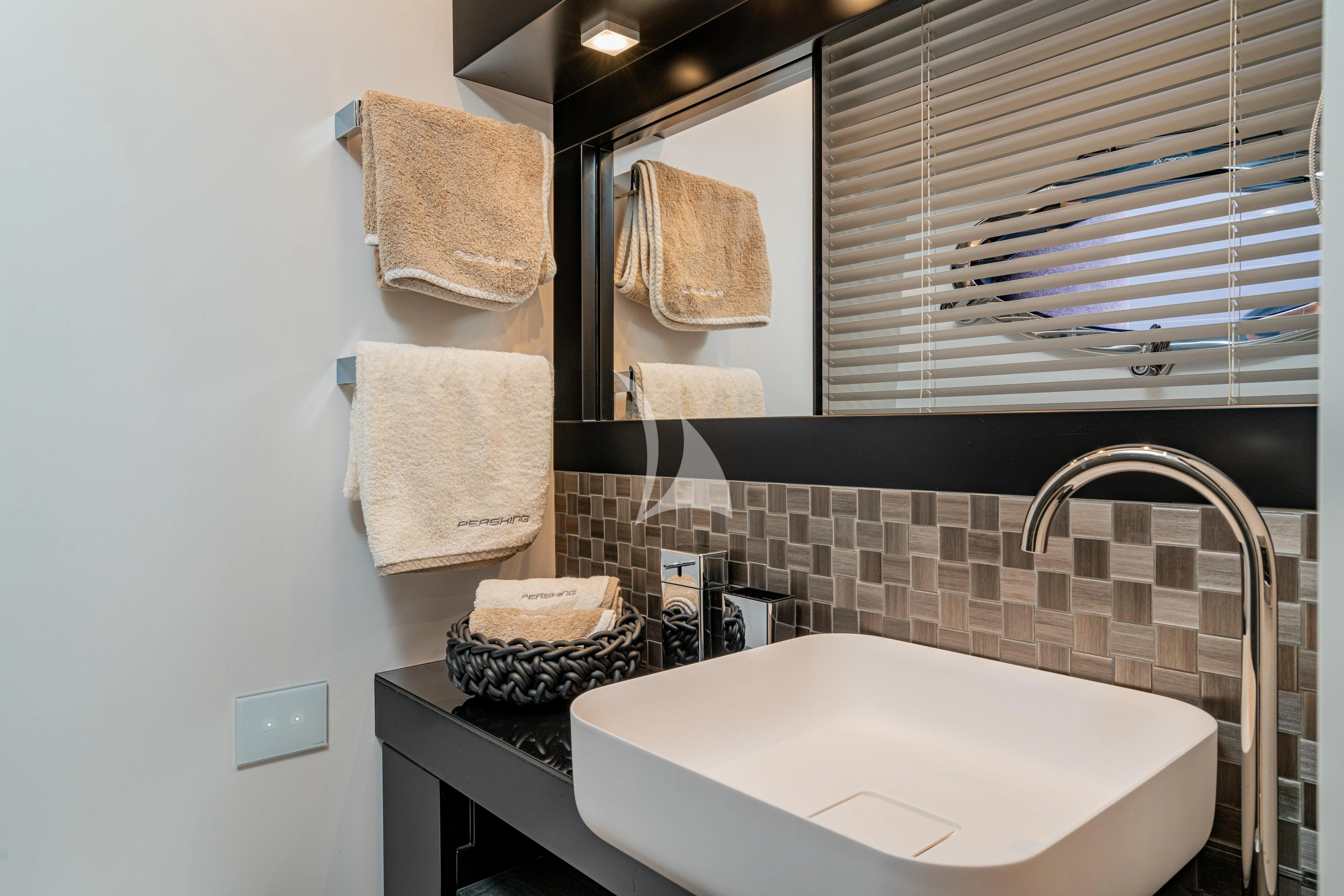 a bathroom with towels on the wall aboard SOPHIA Yacht for Sale
