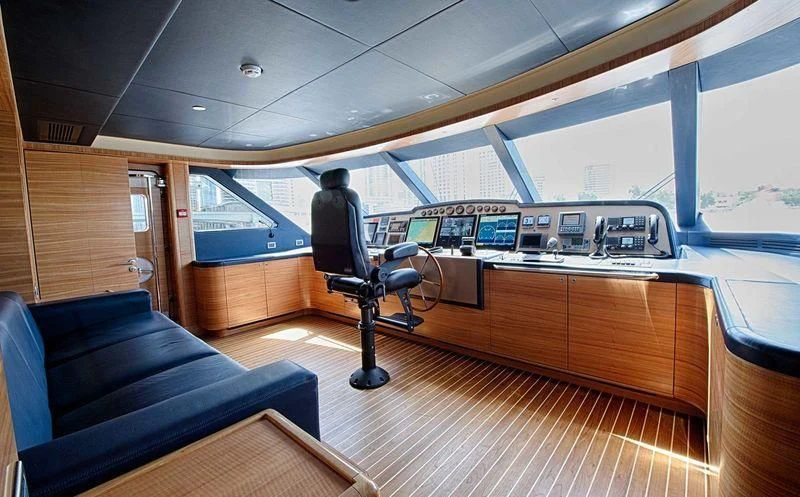 a person sitting in a chair in a boat aboard UAQ 1 Yacht for Sale