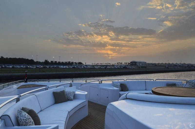 a view of a sunset over a body of water and a city aboard UAQ 1 Yacht for Sale