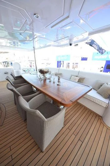 a room with a table and chairs aboard UAQ 1 Yacht for Sale