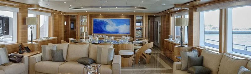 a living room with a large screen aboard UAQ 1 Yacht for Sale