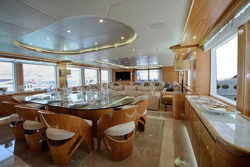 a large dining room with a large table and chairs aboard UAQ 1 Yacht for Sale
