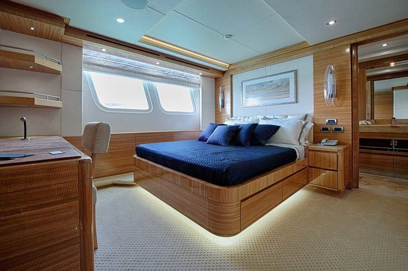 a large bedroom with a bed aboard UAQ 1 Yacht for Sale