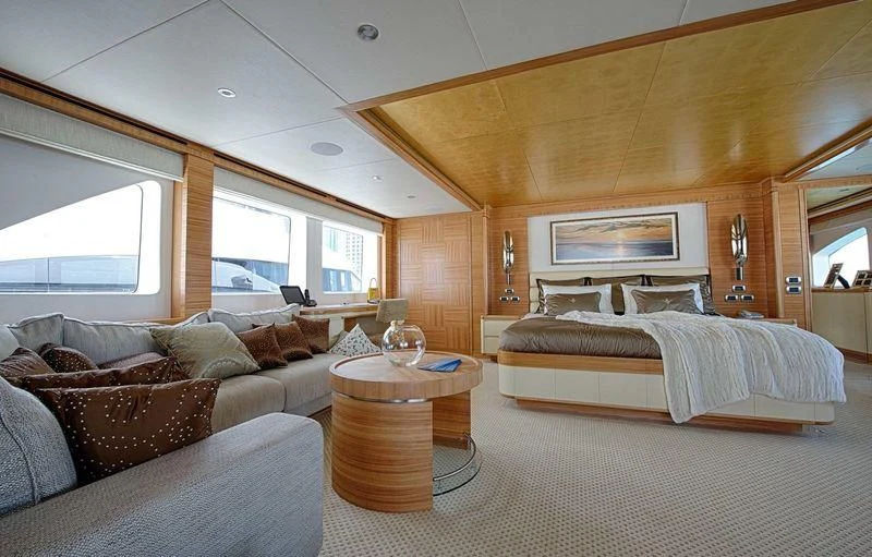 a bedroom with a bed and a table aboard UAQ 1 Yacht for Sale