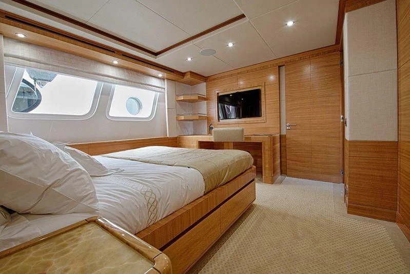 a room with a bed and a tv aboard UAQ 1 Yacht for Sale