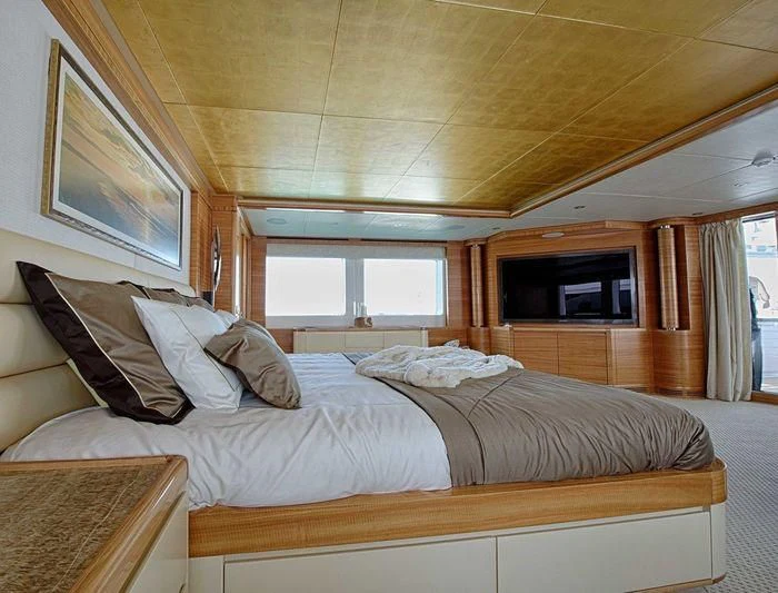 a bedroom with a bed and a television aboard UAQ 1 Yacht for Sale