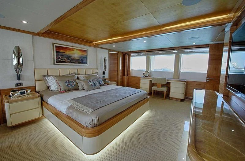 a large bedroom with a large bed aboard UAQ 1 Yacht for Sale