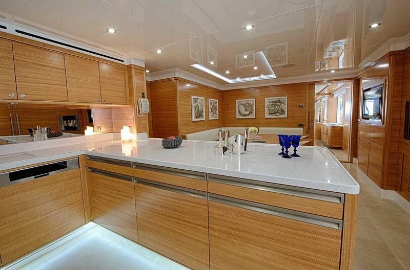 a kitchen with wooden cabinets aboard UAQ 1 Yacht for Sale