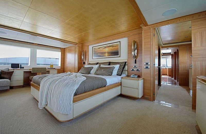 a large bedroom with a large bed aboard UAQ 1 Yacht for Sale