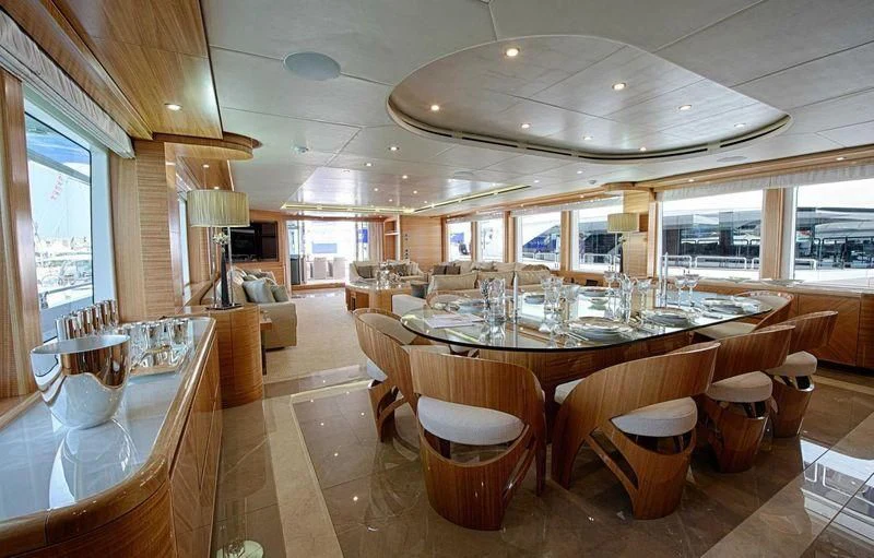 a large dining room with tables and chairs aboard UAQ 1 Yacht for Sale