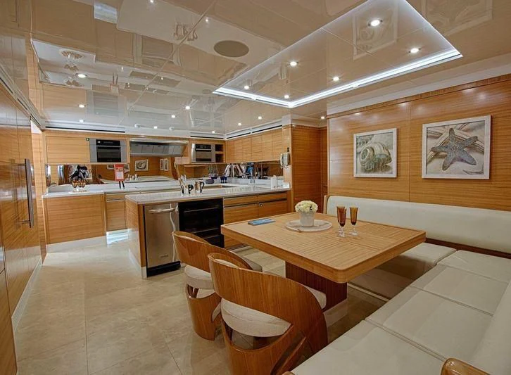 a large kitchen with a table and chairs aboard UAQ 1 Yacht for Sale