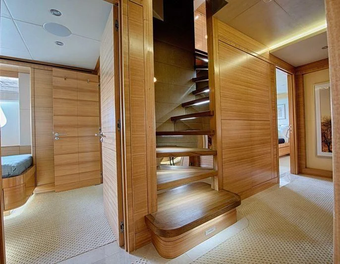 a wooden staircase in a room aboard UAQ 1 Yacht for Sale