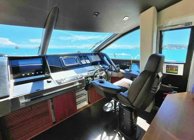 inside of a vehicle with a seat and a seat and a desk with a computer and a blue aboard RAY 3 Yacht for Sale