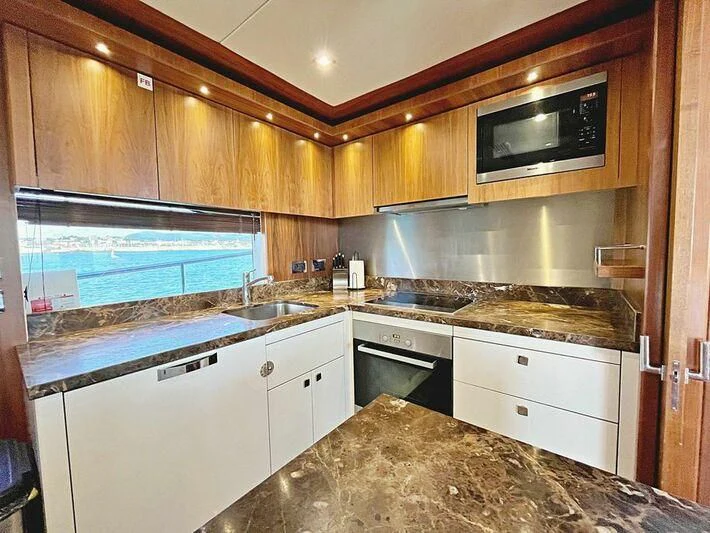 a kitchen with a marble counter top aboard RAY 3 Yacht for Sale