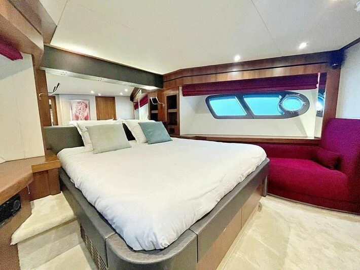 a bedroom with a bed and a chair aboard RAY 3 Yacht for Sale