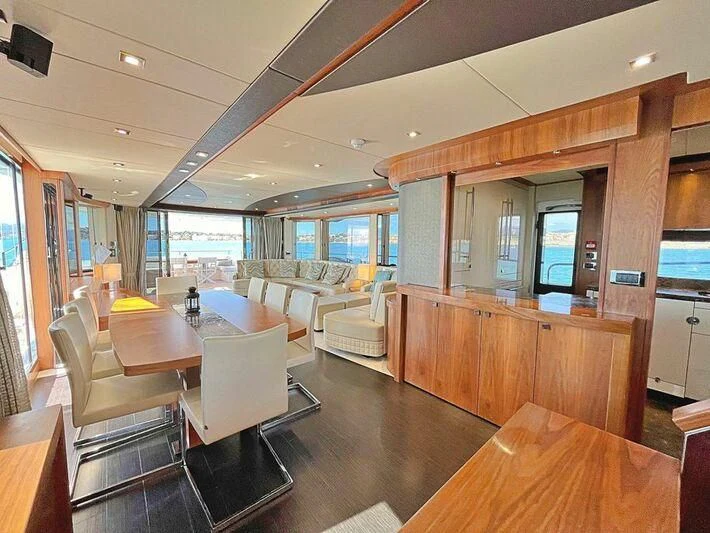 a large room with a table and chairs aboard RAY 3 Yacht for Sale