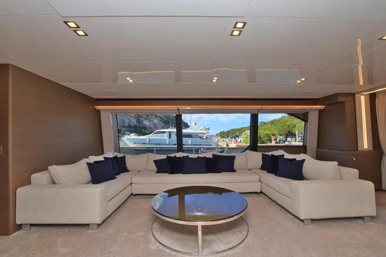 a living room with a large window aboard BLESSED ONE Yacht for Sale