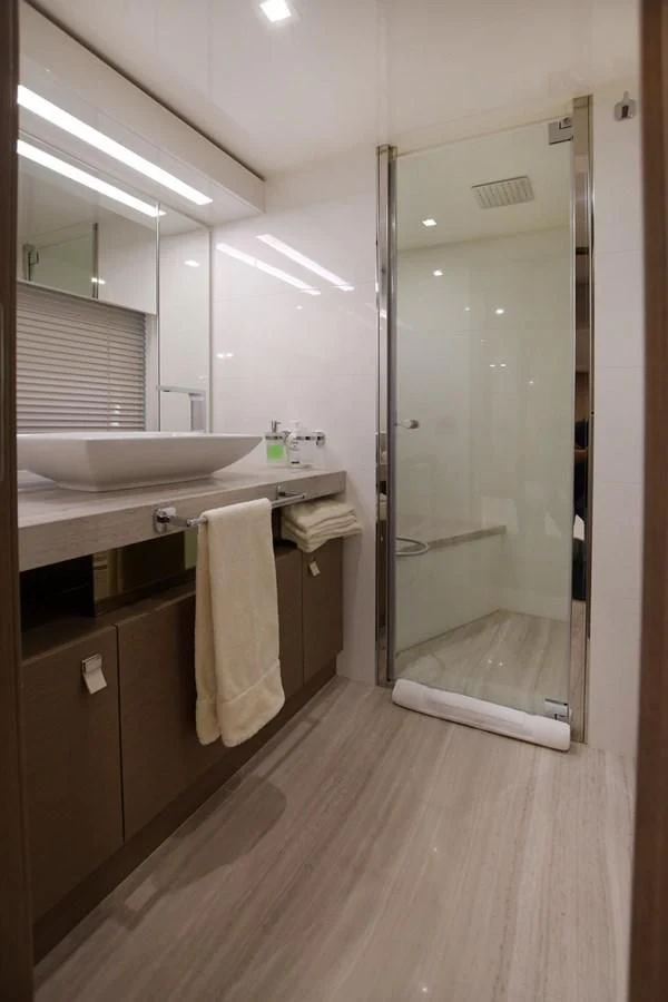 a bathroom with a shower unit and sink aboard BLESSED ONE Yacht for Sale