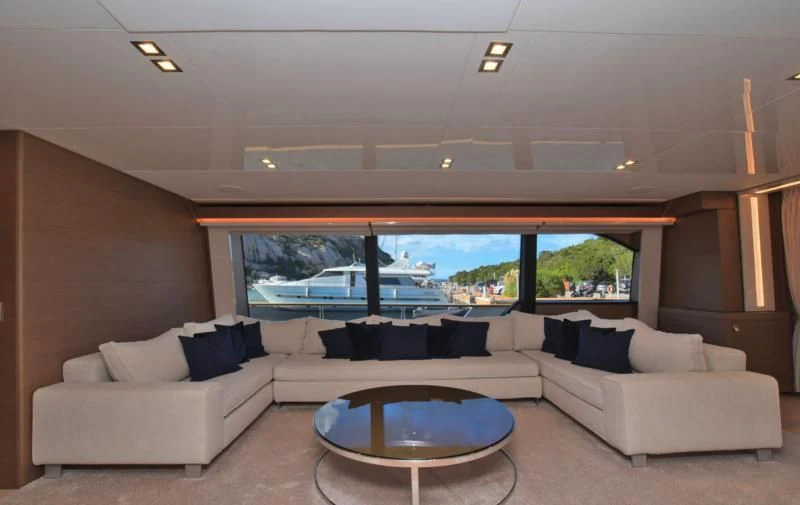 a living room with a large window aboard BLESSED ONE Yacht for Sale