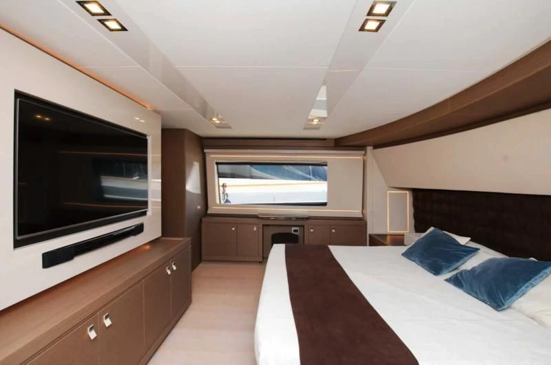 a bedroom with a large tv aboard BLESSED ONE Yacht for Sale