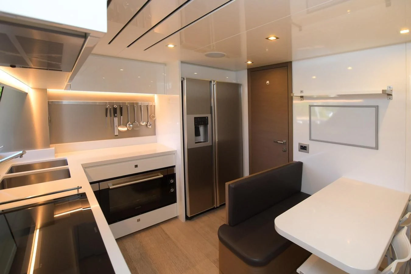 a kitchen with a table and chairs aboard BLESSED ONE Yacht for Sale