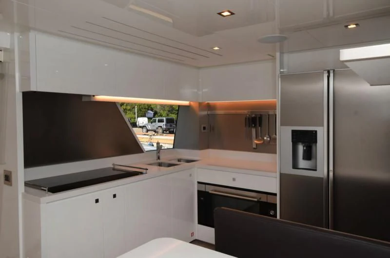 a kitchen with a large tv aboard BLESSED ONE Yacht for Sale