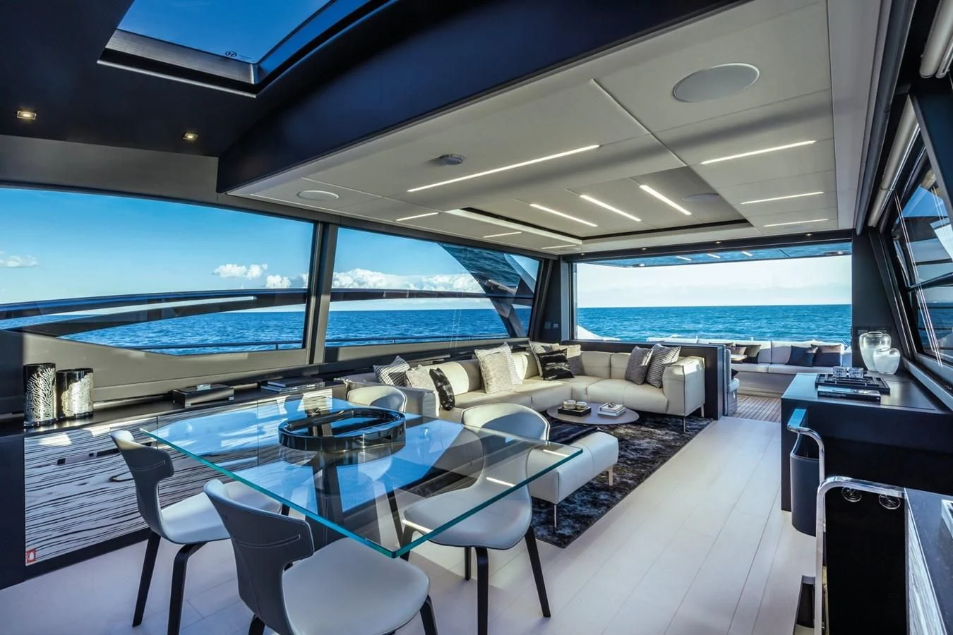 a room with a table chairs and a large window aboard PERSHING 8X Yacht for Sale