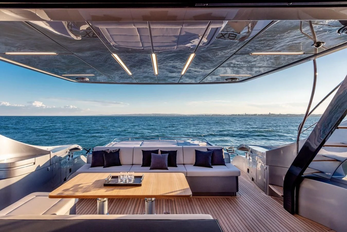 a deck with a view of the ocean and a boat aboard PERSHING 8X Yacht for Sale