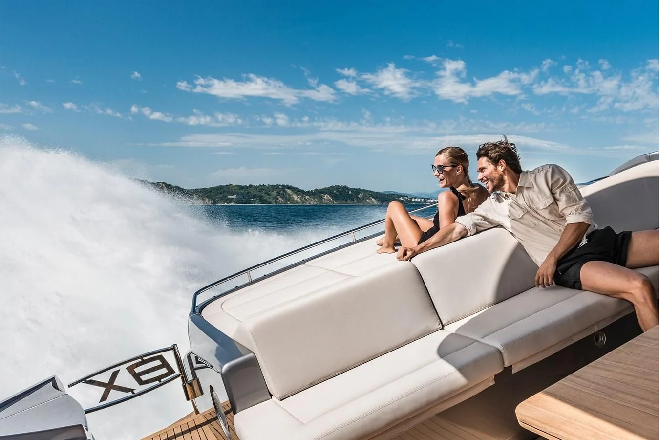 a man and woman sitting on a boat in the water aboard PERSHING 8X Yacht for Sale