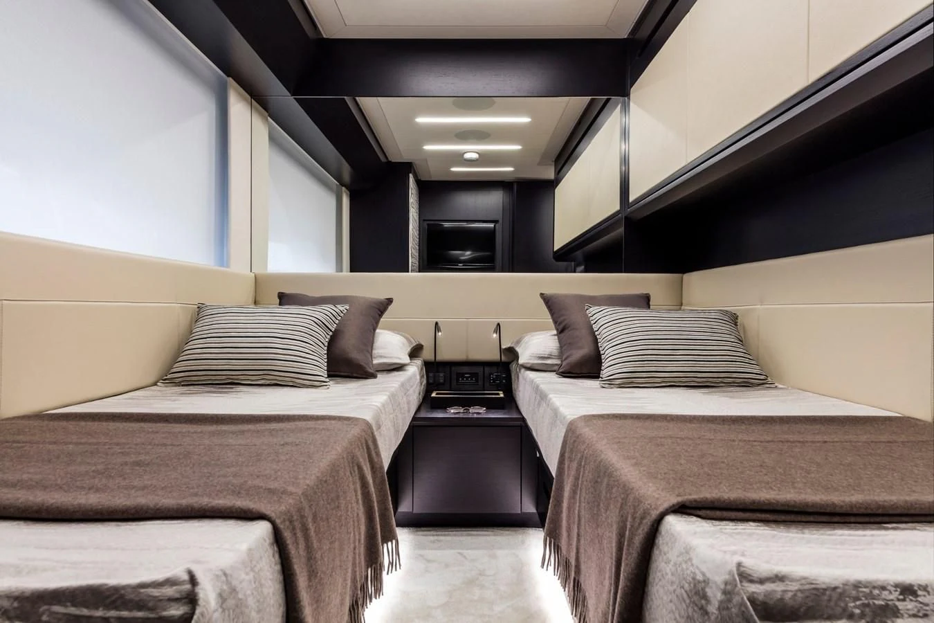 a room with beds and a window aboard PERSHING 8X Yacht for Sale