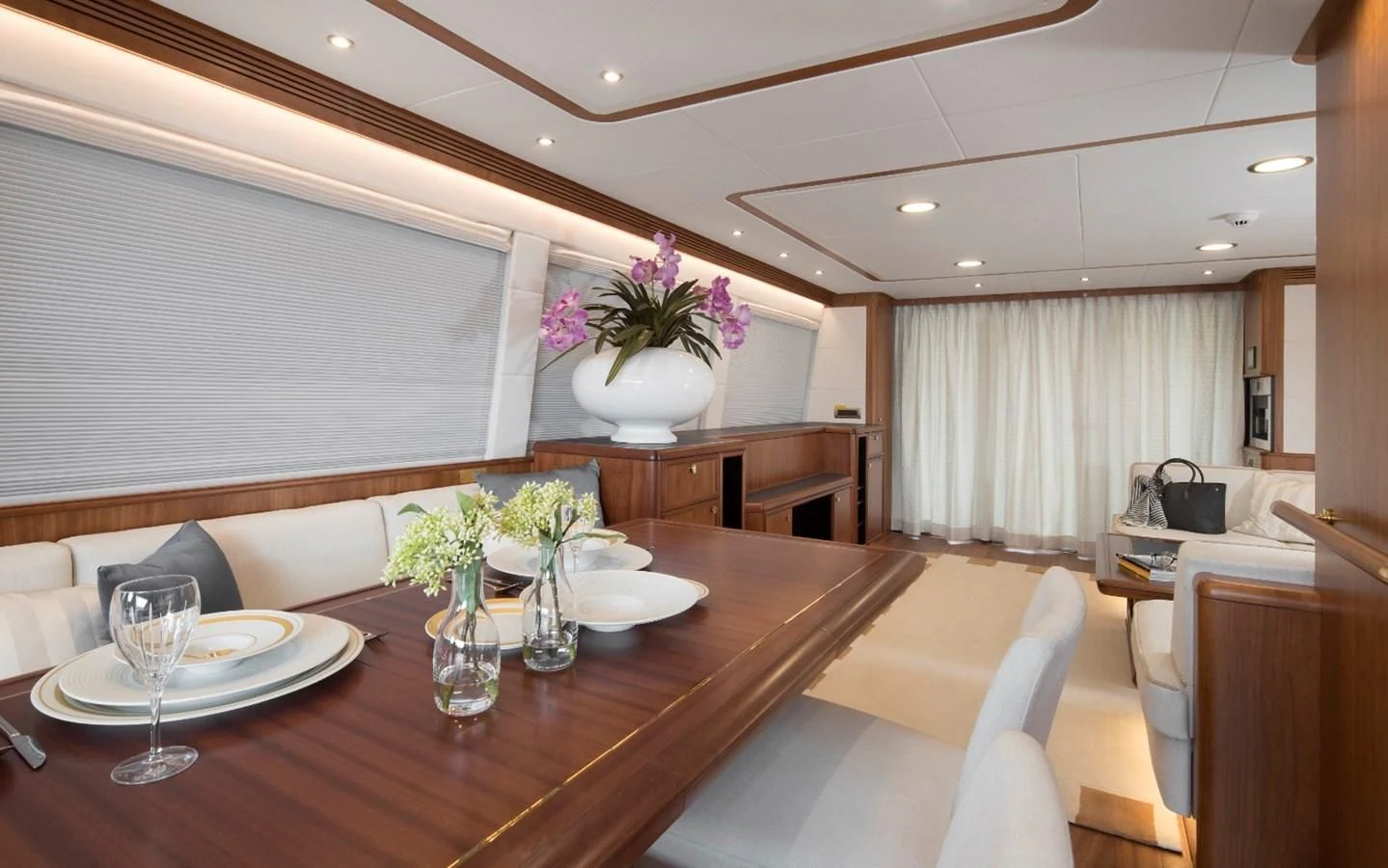 a dining table with flowers aboard VALENCIA Yacht for Sale