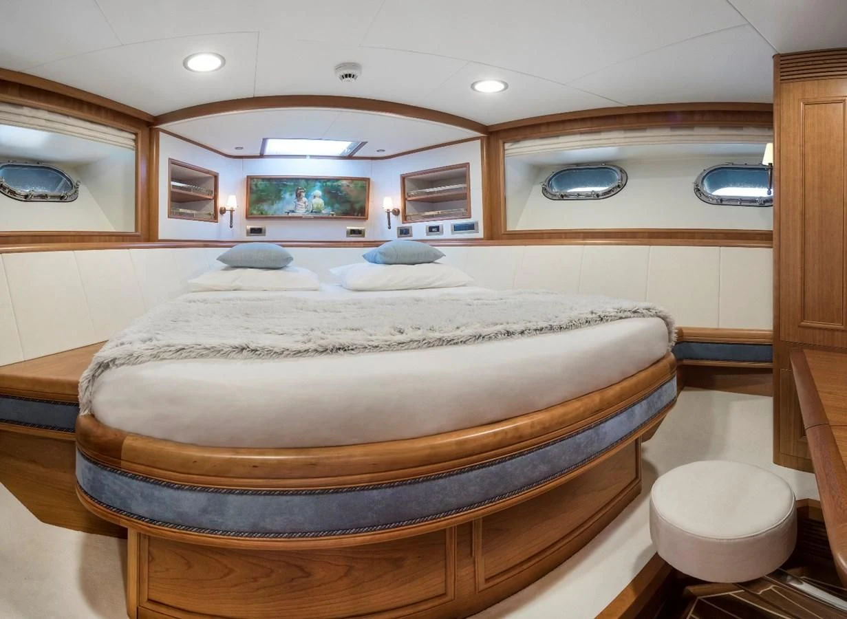 a large bed with a white cover aboard VALENCIA Yacht for Sale