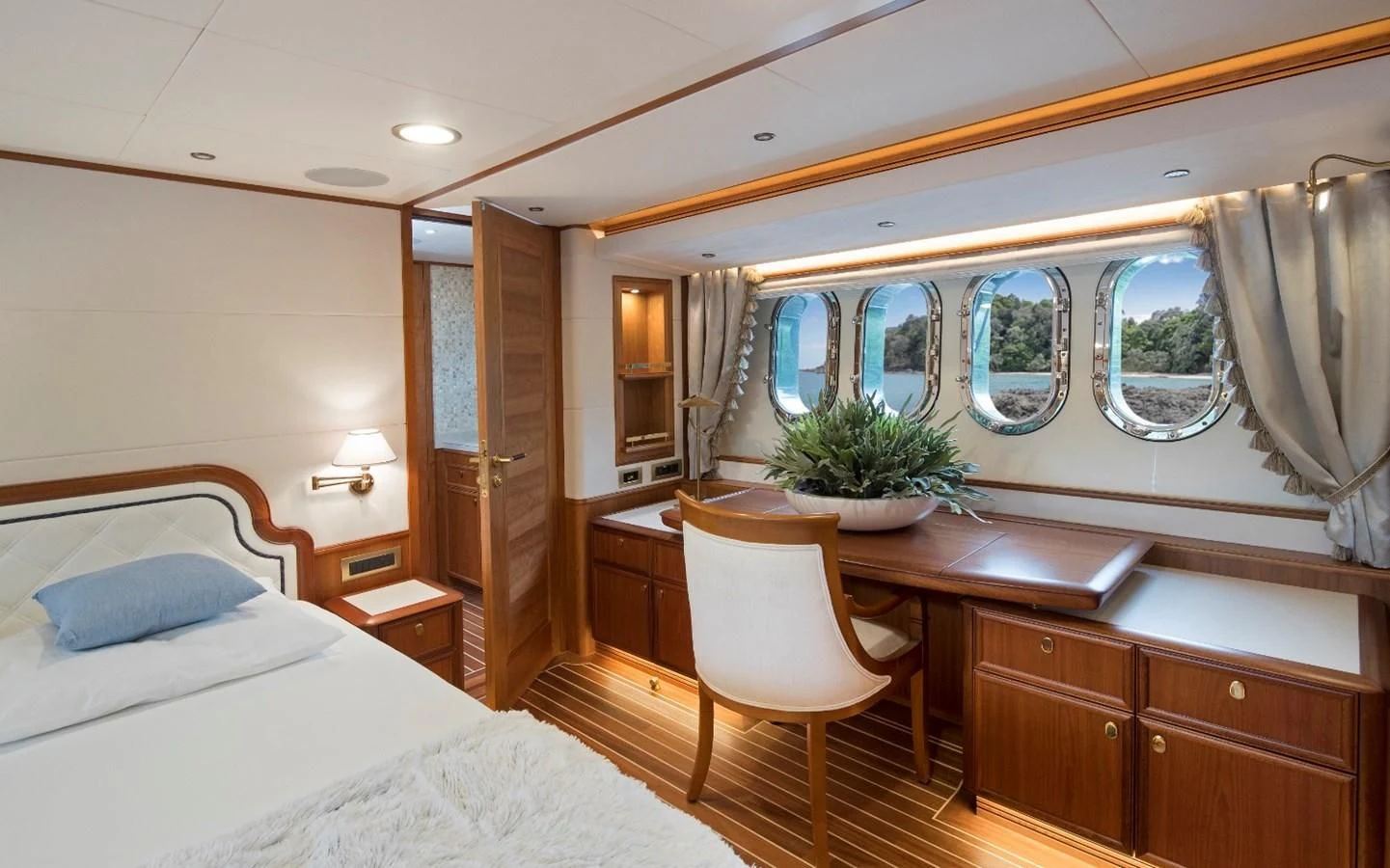 a room with a bed and desk aboard VALENCIA Yacht for Sale
