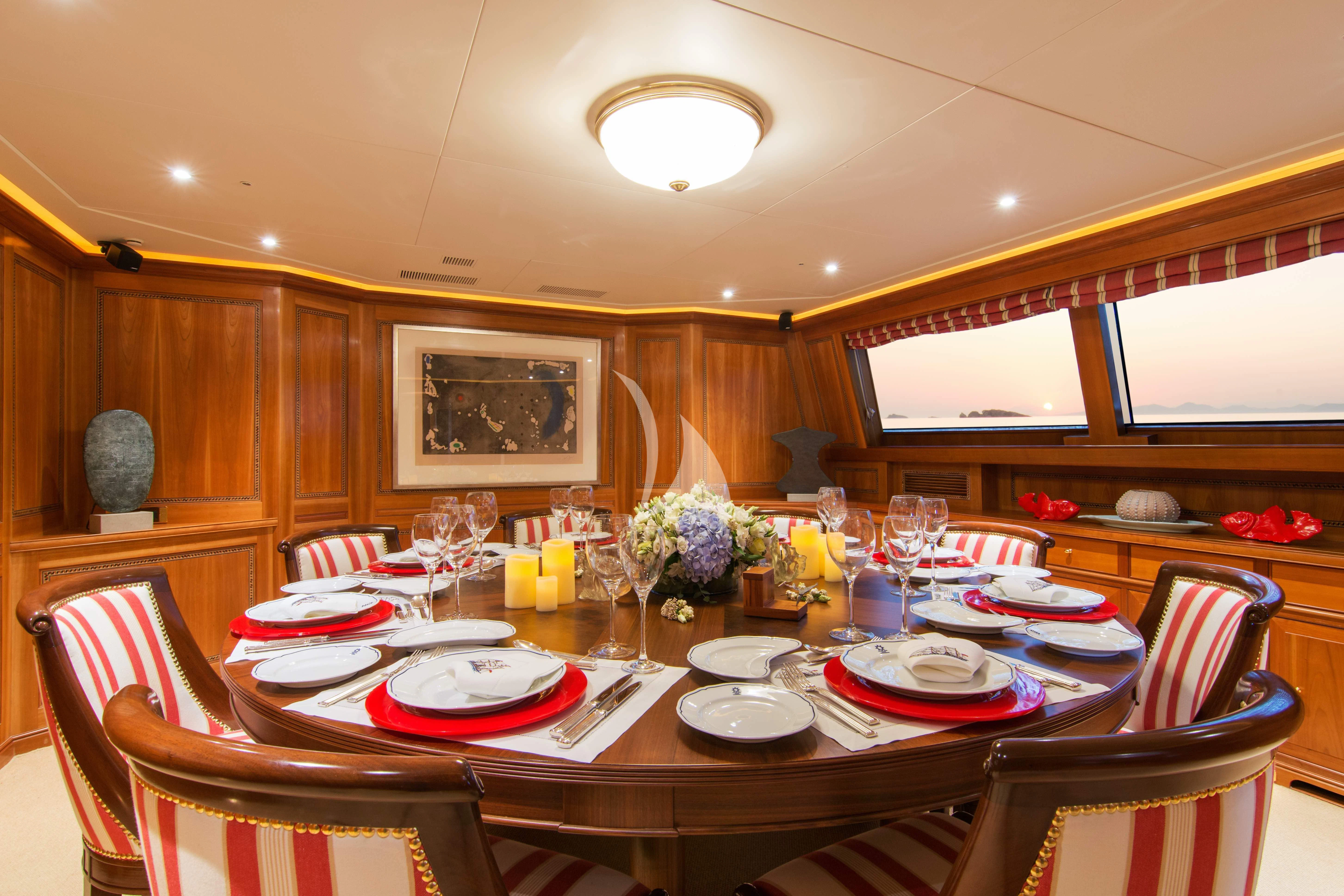 a dining room with a table set for a meal aboard XASTERIA Yacht for Charter