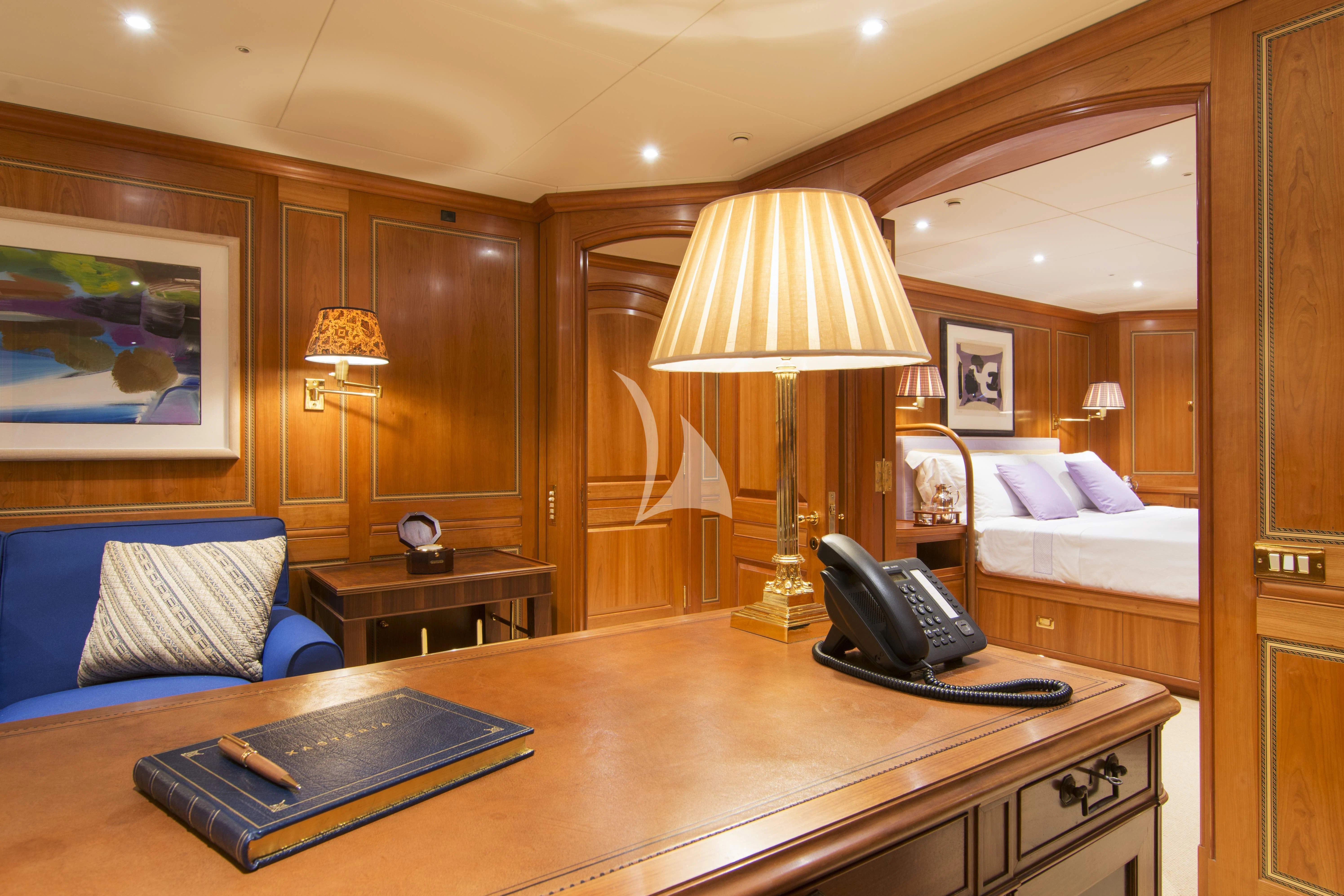 a hotel room with a bed and a desk aboard XASTERIA Yacht for Charter