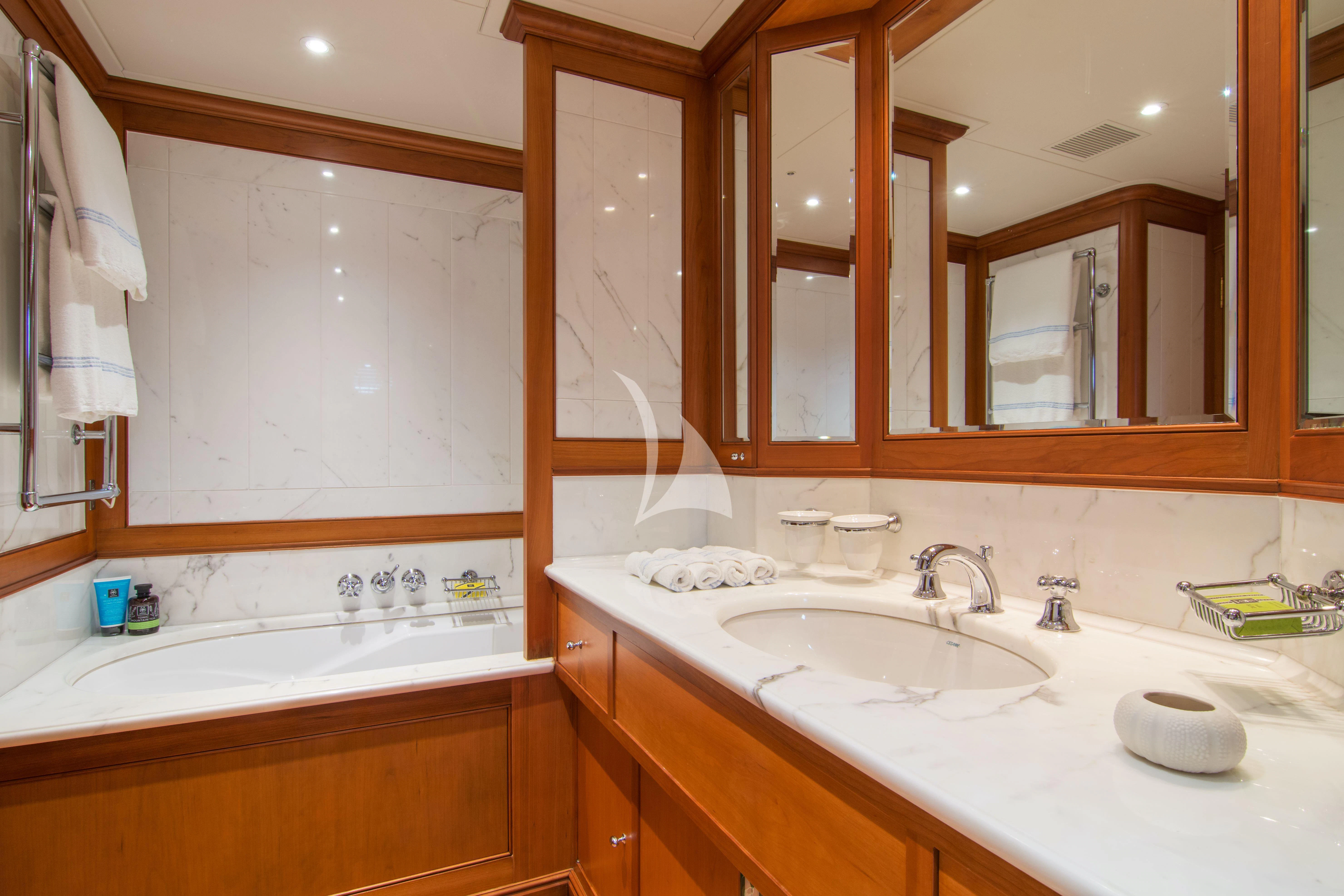 a bathroom with a sink and a mirror aboard XASTERIA Yacht for Charter