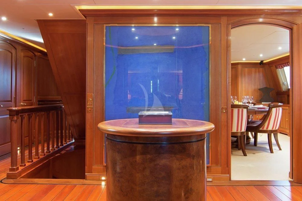 a room with a table and chairs aboard XASTERIA Yacht for Charter