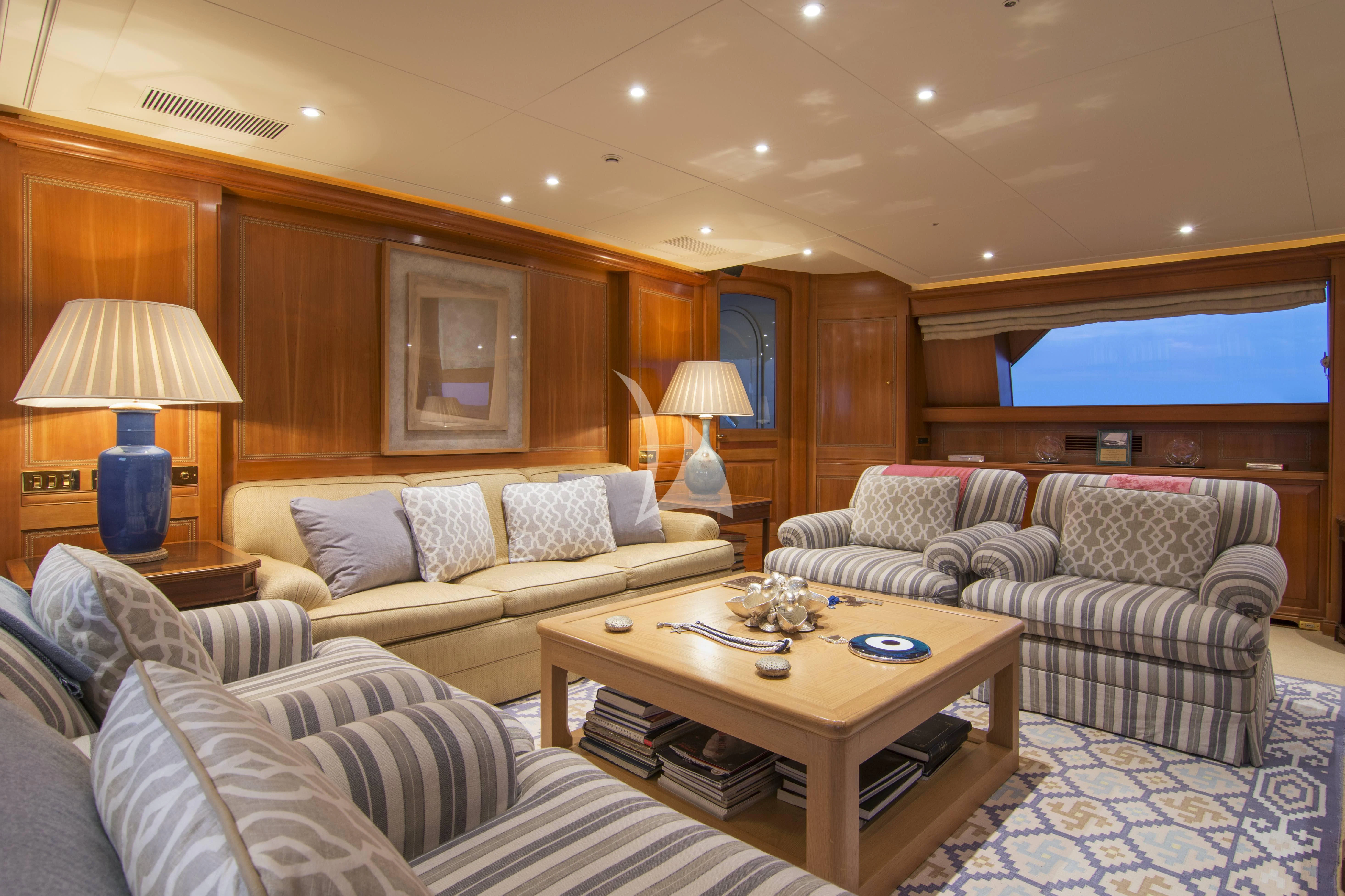 a living room with a couch and a coffee table aboard XASTERIA Yacht for Charter