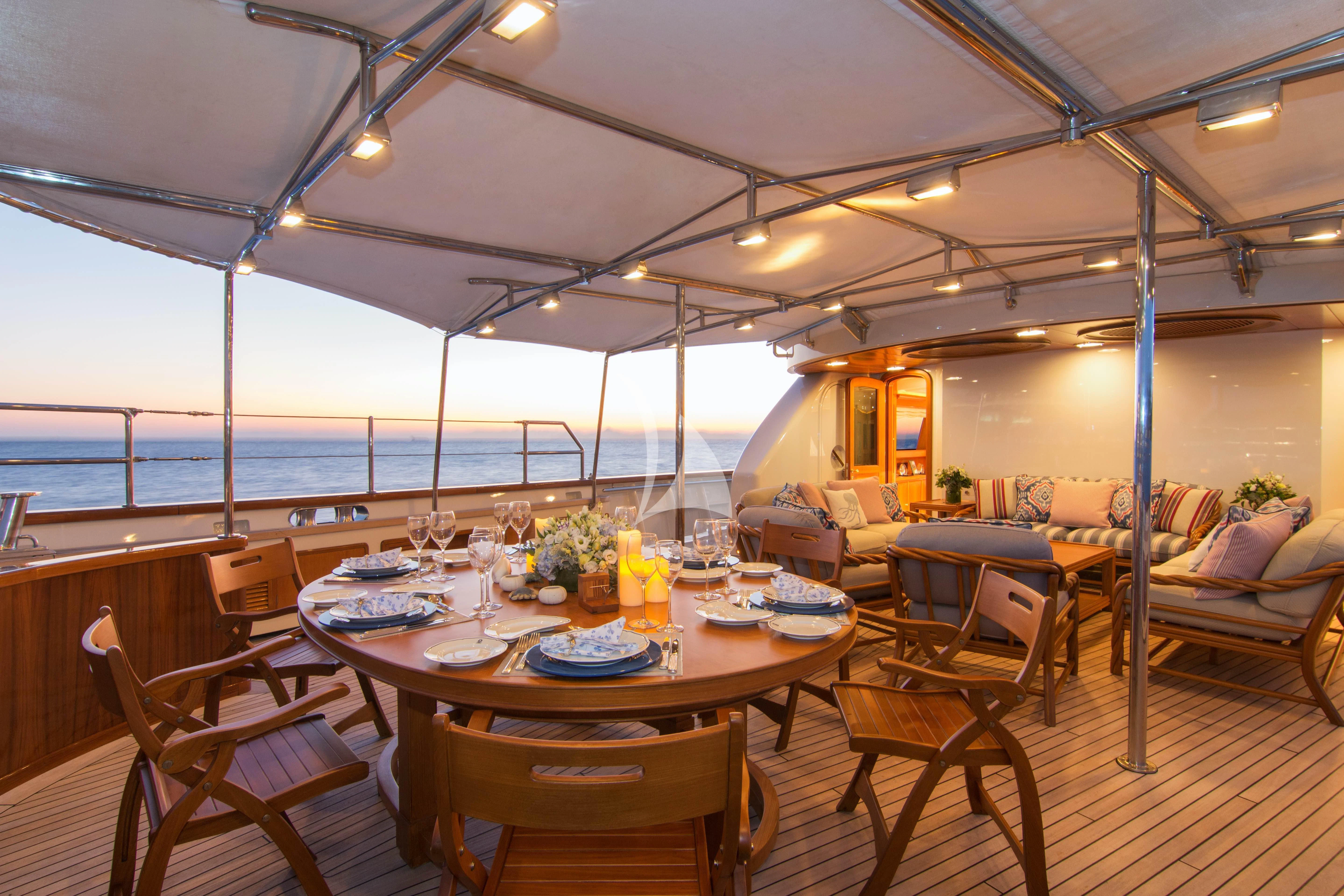 a dining room with a large body of water in the background aboard XASTERIA Yacht for Charter