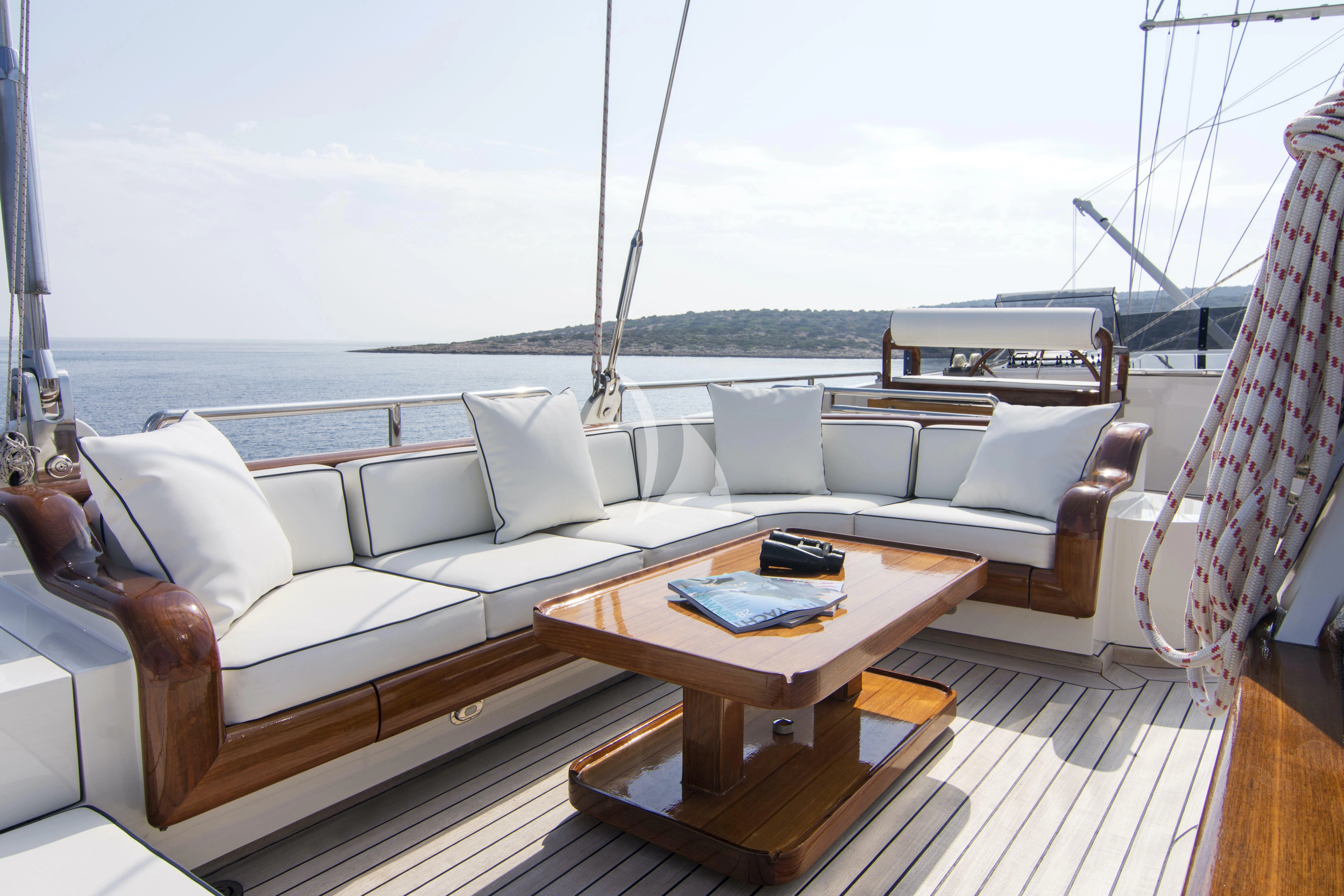 a living room with a large balcony aboard XASTERIA Yacht for Charter