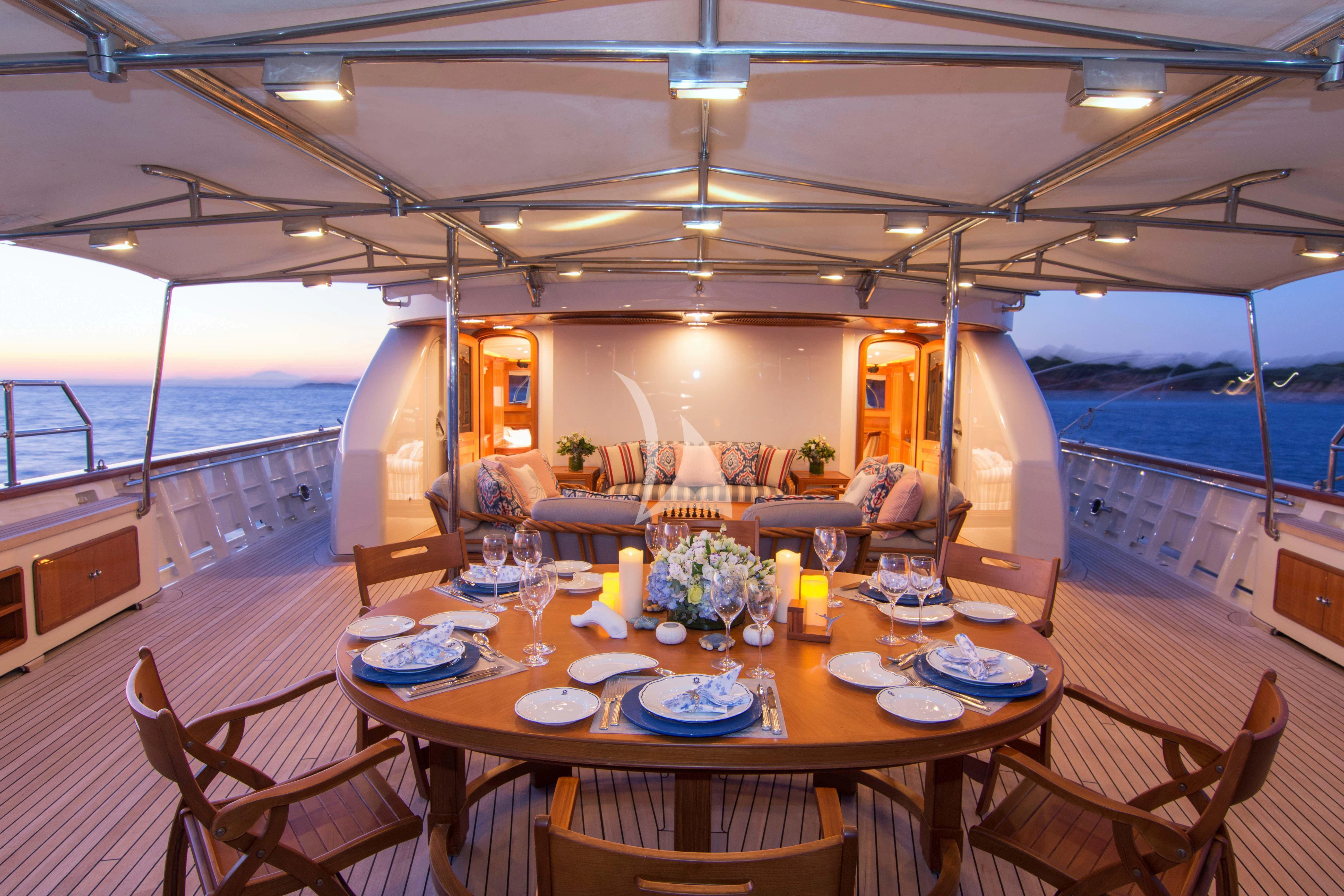 a dining table set for a dinner aboard XASTERIA Yacht for Charter