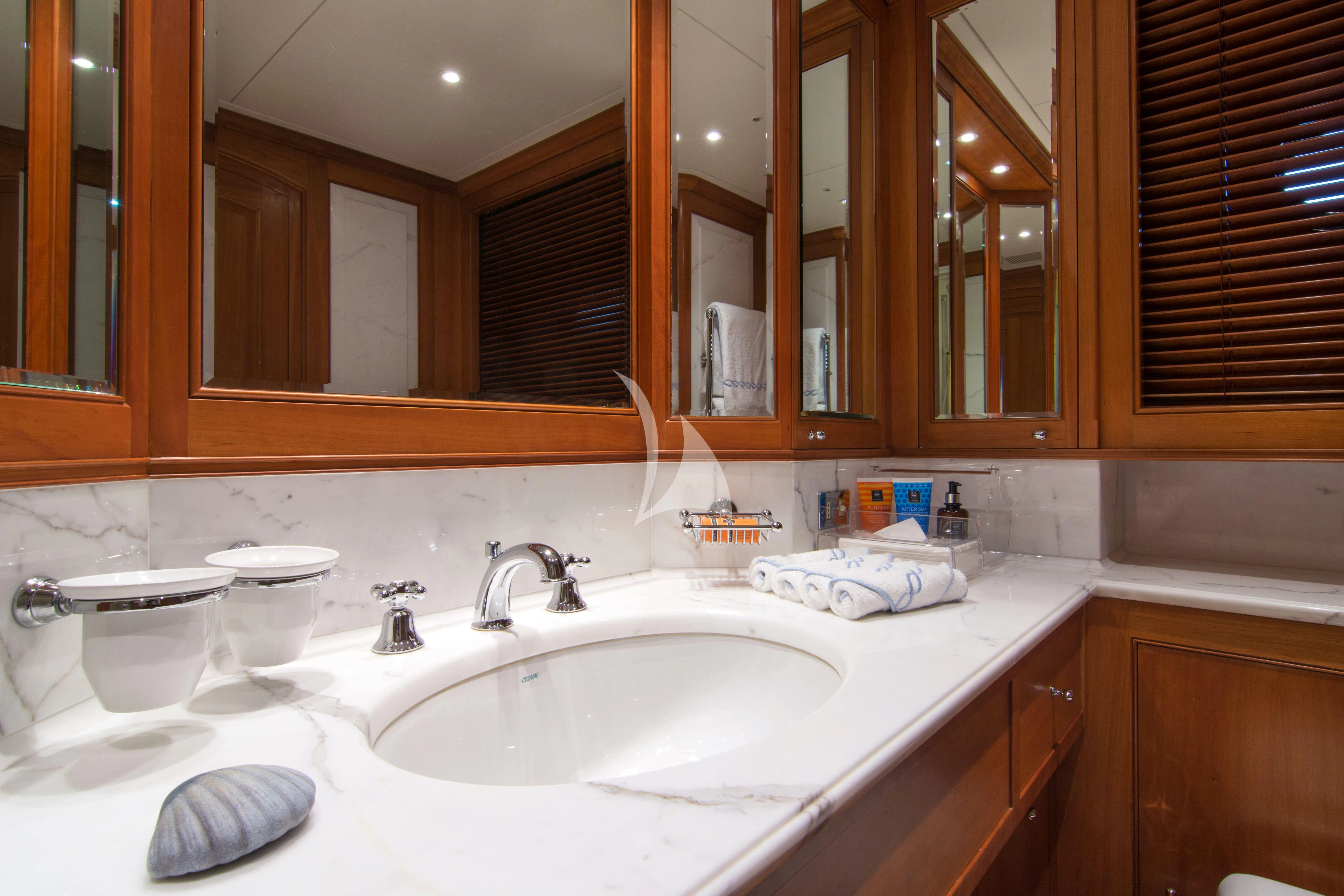 a bathroom with a sink and a mirror aboard XASTERIA Yacht for Charter