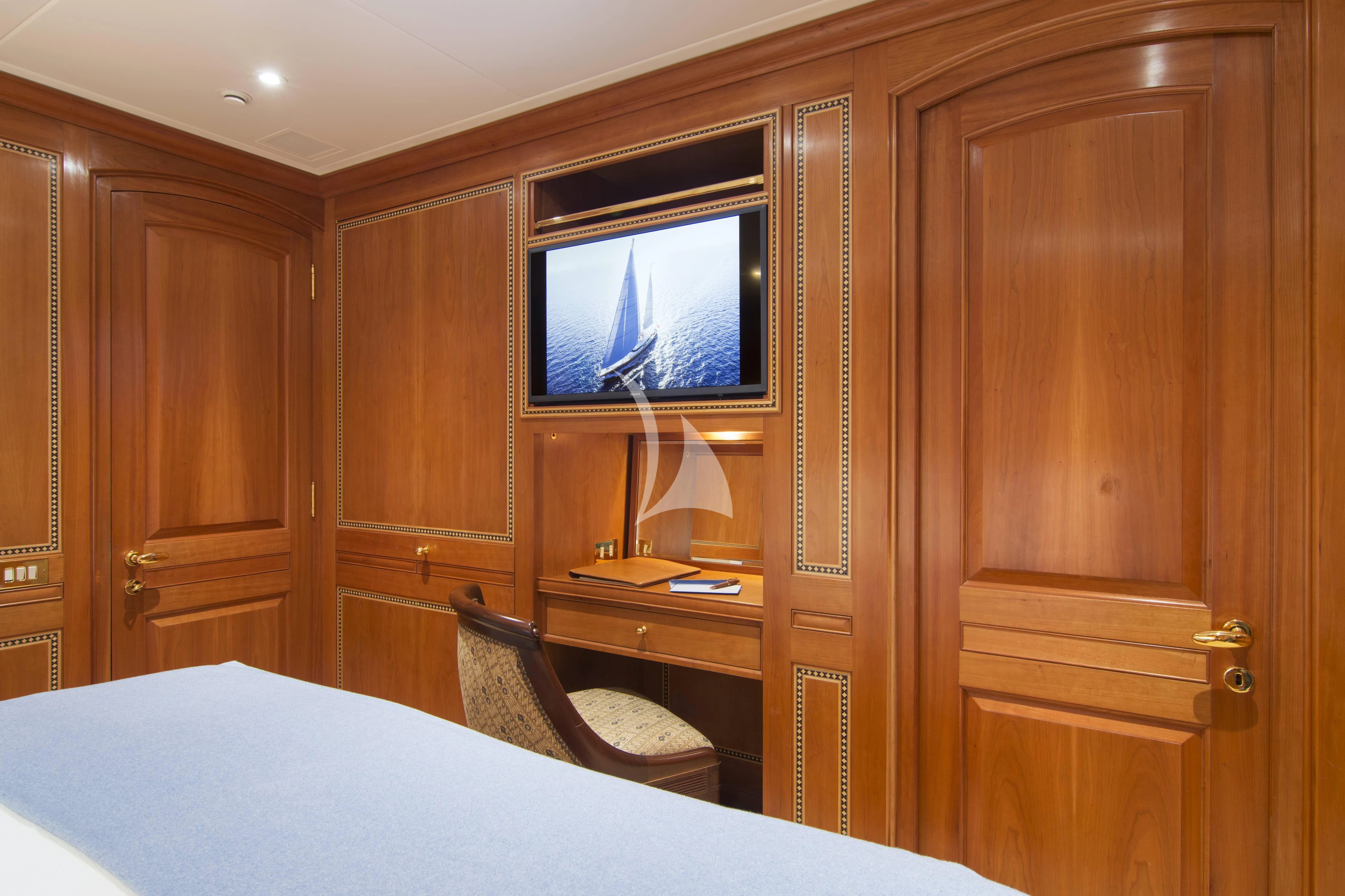 a room with a television and a bed aboard XASTERIA Yacht for Charter